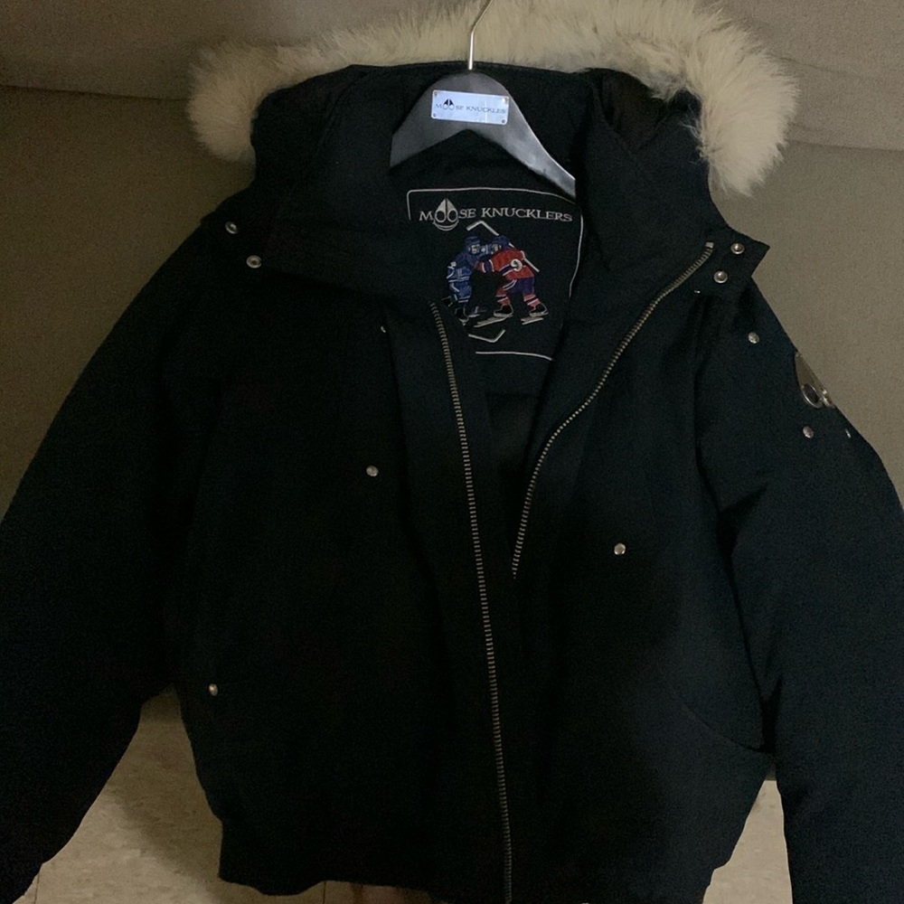 Navy blue moose knuckle with white fur in a kids large